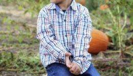 Pumpkin Patch - little boy sitting on pumpkin